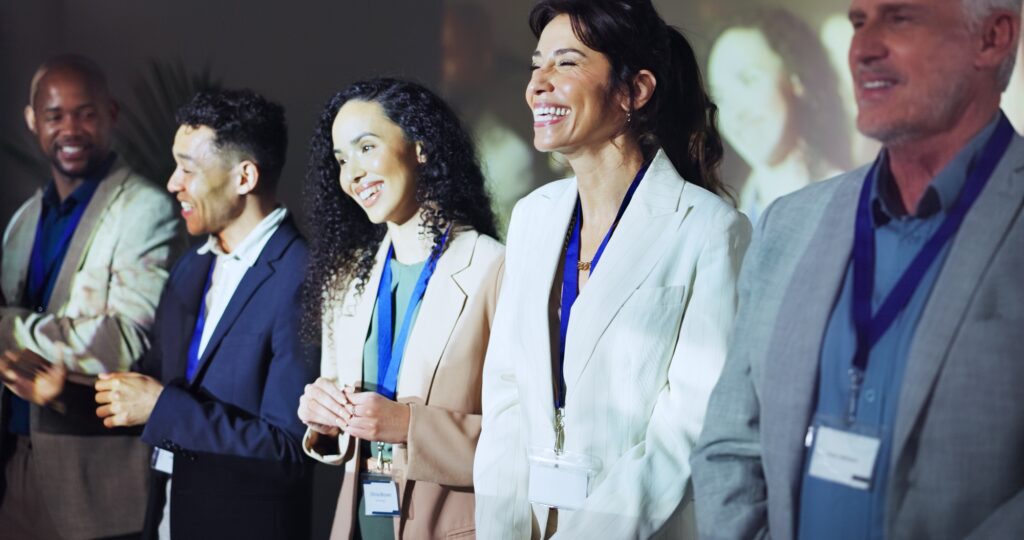 Presentation, conference and happy business people on a stage at tradeshow, convention and seminar.